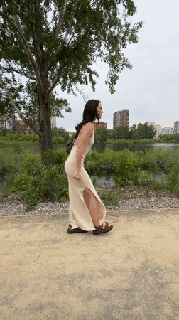 Woman strolls riverside park path in Tyumen, Russia