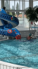 Children swim at Andrézieux-Bouthéon aquatic center midday