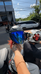 Motorcycle passengers film selfie videos in Kuta traffic