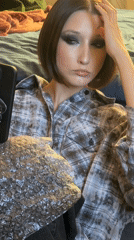 Woman in plaid shirt observed indoors in Belarus village