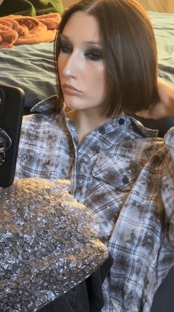 Woman in plaid shirt observed indoors in Belarus village