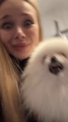 Blonde woman documented through evening activities with Pomeranian dog