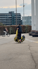 Worker moves electric scooters near Olympic stadium in Sirius