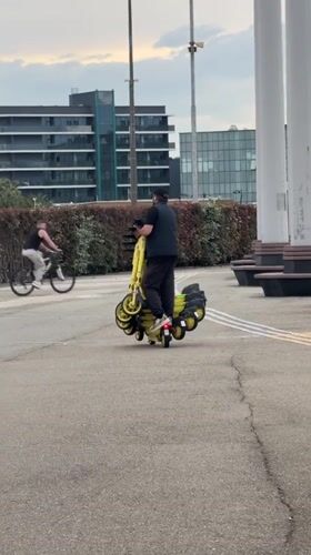 Worker moves electric scooters near Olympic stadium in Sirius