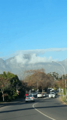 Routine traffic captured on Somerset West streets beneath cloudy mountains
