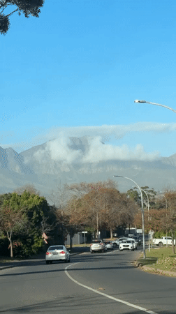 Routine traffic captured on Somerset West streets beneath cloudy mountains