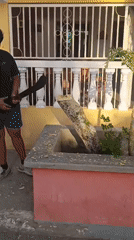 Man chops tree stump with machete in Juan Griego