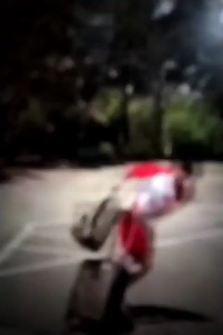 The video shows a person in a red and white costume at an airport. The person is carrying a large backpack. The person is walking through the airport terminal. The video then cuts to a shot of an airplane flying in the sky.