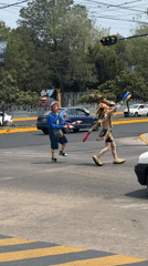 Street performers juggle at Puebla crosswalk during evening show
