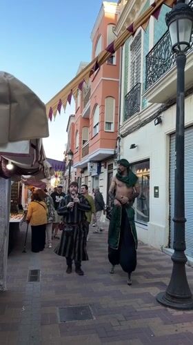 Traditional performers appear at Burjassot marketplace among plant vendors