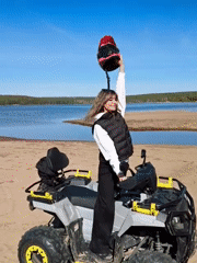 Woman with ATV enjoys lakeside moment in Chaikovsky, Russia