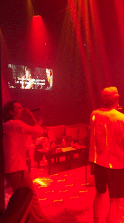 Two men perform karaoke in Baan Bang Rak venue