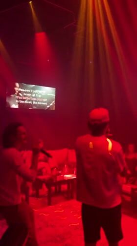 Two men perform karaoke in Baan Bang Rak venue