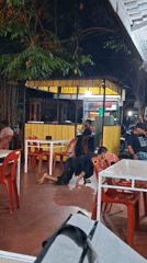 Man crawls with chairs, modified motorcycles seen in Indonesian city