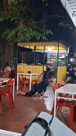 Man crawls with chairs, modified motorcycles seen in Indonesian city
