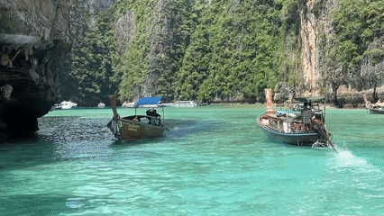 Longtail boats navigate Ao Nang's iconic limestone karst waters