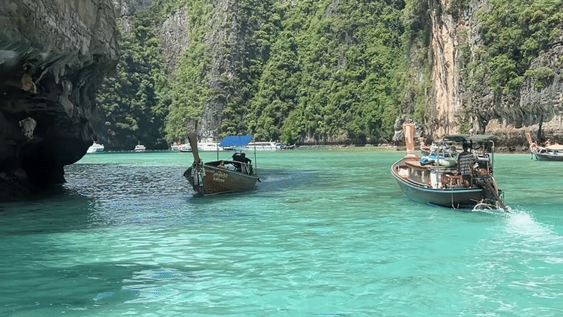 Longtail boats navigate Ao Nang's iconic limestone karst waters