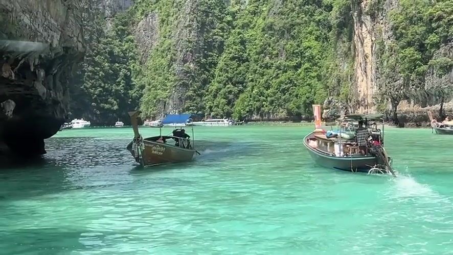 Longtail boats navigate Ao Nang's iconic limestone karst waters