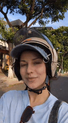 Woman records video while sitting on scooter in Đà Nẵng