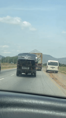 Van transports large wooden structure on Nigerian highway