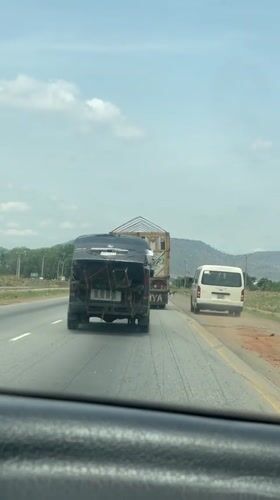 Van transports large wooden structure on Nigerian highway