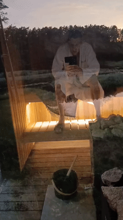 Sauna selfie reflected in glass door