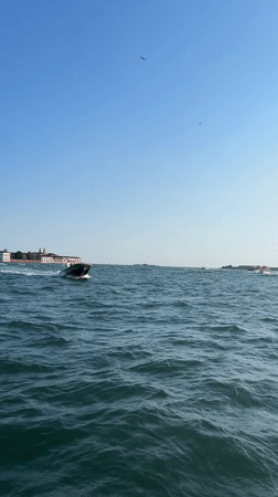Speedboat cutting through Venetian waters at pace