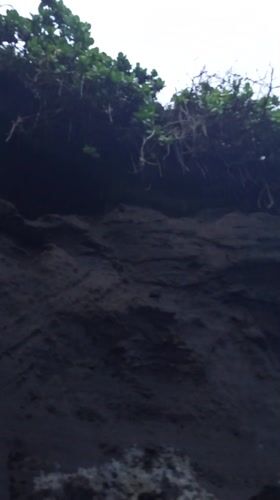Rocky coastline documented during overcast conditions in Mengwi, Indonesia