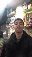 Young man makes peace sign in Juan Griego store