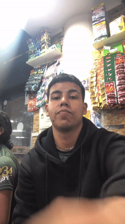 Young man makes peace sign in Juan Griego store