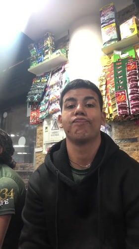 Young man makes peace sign in Juan Griego store