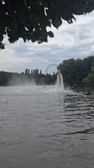Flyboarding over Moscow water with a Ferris wheel backdrop