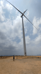 Person waves from wind turbine platform in Vietnam