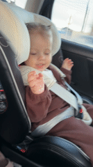 Toddler secured in car seat during journey in Klin
