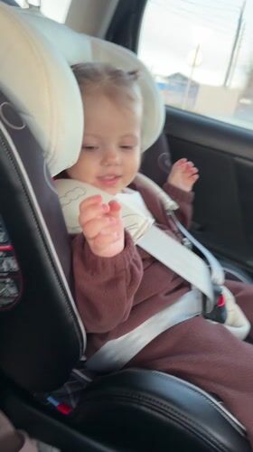Toddler secured in car seat during journey in Klin