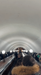 Tourists document overcast afternoon at Moscow's Red Square landmarks