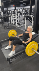 Woman performs barbell hip thrusts at Choeng Mon gym