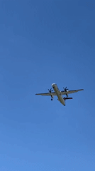 Twin-engine aircraft approaches Luxembourg with landing gear down