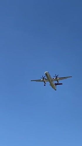 Twin-engine aircraft approaches Luxembourg with landing gear down