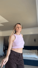 Woman dances to music in bedroom in Carnikava