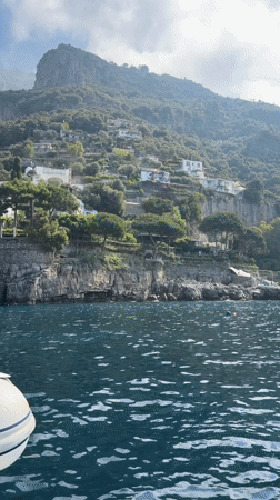 Boat passengers enjoy scenic Amalfi Coast waters near Positano