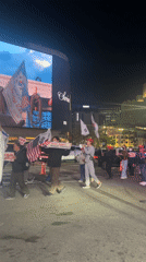 Night demonstration in Seoul features Korean-American flags, protest signs