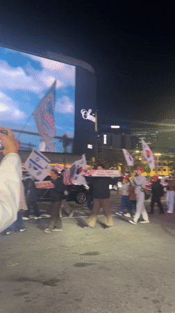 Night demonstration in Seoul features Korean-American flags, protest signs