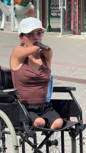 Wheelchair user with mic on Kazan pedestrian street