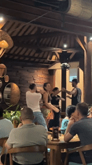 Couples enjoy social dancing at Ubud restaurant gathering