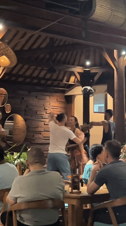 Couples enjoy social dancing at Ubud restaurant gathering