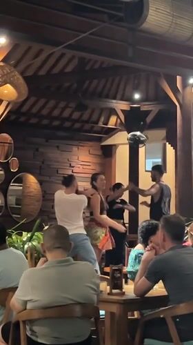 Couples enjoy social dancing at Ubud restaurant gathering