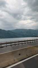 Morning highway travel recorded along lakeside road in Italy