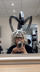 Woman documents salon hair highlighting session in French spa town