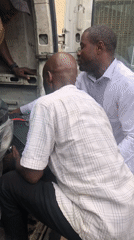 Vehicle repairs and roadside work underway in Ikeja, Nigeria